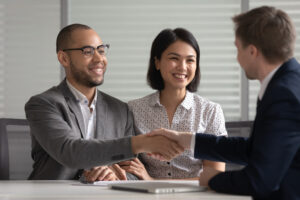 Man and woman shaking hands with a lawyer