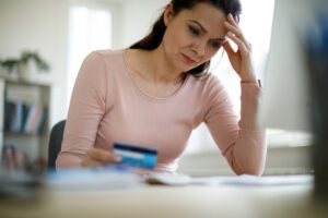 Woman looking at papers and a credit card